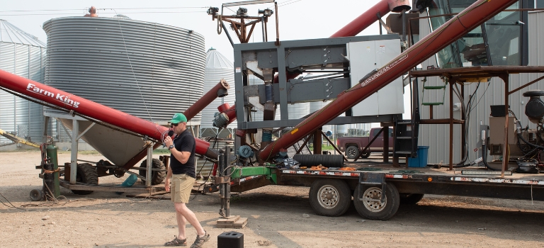 Colin Rosengren presenting in front of the customized harvester at Avena CAFAD 2024