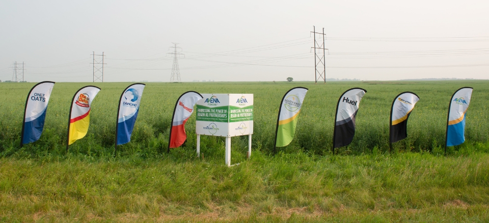 Sign and flags at Avena Customer and Farmer Appreciation Day 2024 Tour