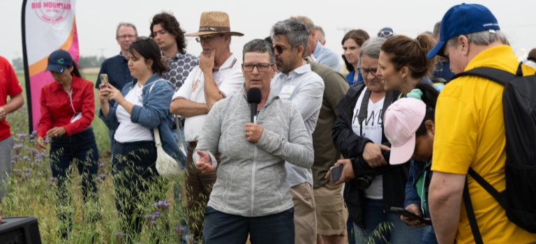 Shannon Knibbs speaking at fields at Avena Customer and Farmer Appreciation Day 2024 Tour